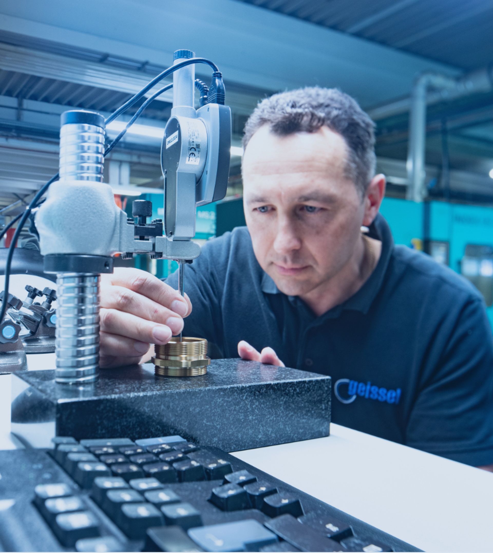 A quality control employee measures the manufacturing tolerances of a turned part